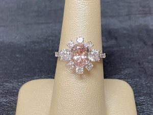 custom ring made in white gold with morganite center stone surrounded by diamonds